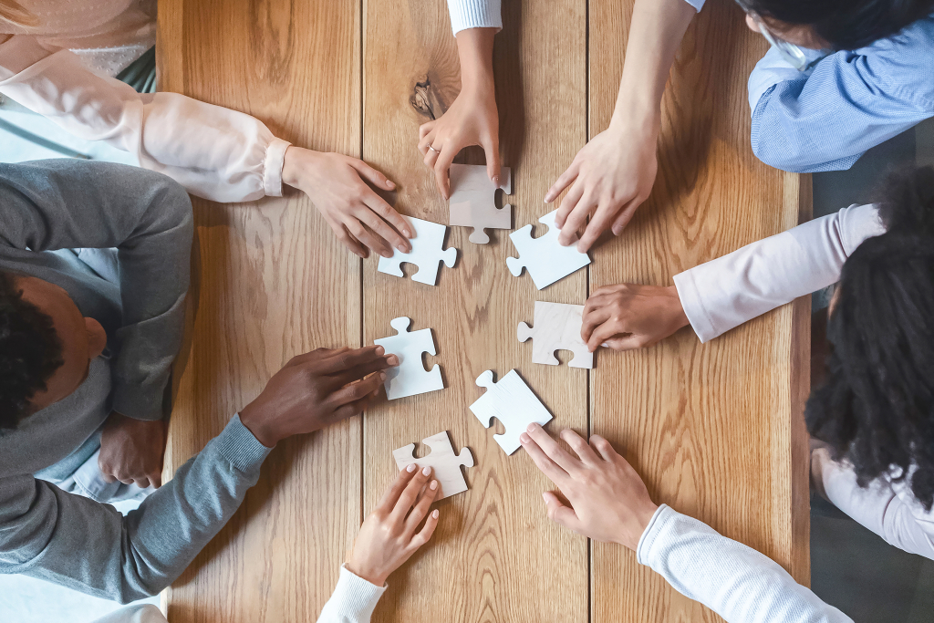 team-collaboration-completing-puzzle-on-wooden-tab-2026-03-24-03-18-39-utc-1024x683-1